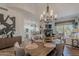 Inviting dining room with a chandelier, connecting to a living area with a fireplace and a modern white kitchen at 19475 N Grayhawk Dr # 1039, Scottsdale, AZ 85255