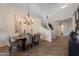 Chic dining room with a modern chandelier and staircase in a bright setting at 19475 N Grayhawk Dr # 1039, Scottsdale, AZ 85255