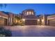 Inviting home exterior with a stone accent garage and desert landscaping at 19475 N Grayhawk Dr # 1039, Scottsdale, AZ 85255
