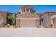 Home exterior with a stone accent garage and desert landscaping on a sunny day at 19475 N Grayhawk Dr # 1039, Scottsdale, AZ 85255