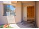 Inviting front entrance with a solid wood door and decorative plants at 19475 N Grayhawk Dr # 1039, Scottsdale, AZ 85255