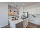 Stylish kitchen featuring white cabinets, stainless steel appliances, and an island with a sink and dishwasher at 19475 N Grayhawk Dr # 1039, Scottsdale, AZ 85255