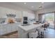 Modern kitchen with white cabinets, quartz countertops, stainless appliances, and a large island with seating at 19475 N Grayhawk Dr # 1039, Scottsdale, AZ 85255