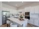 Contemporary kitchen with white cabinetry, stainless steel appliances, and a center island with seating at 19475 N Grayhawk Dr # 1039, Scottsdale, AZ 85255