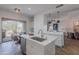 Bright kitchen with an island sink, stainless steel appliances, and sliding doors to an outdoor dining area at 19475 N Grayhawk Dr # 1039, Scottsdale, AZ 85255