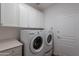 Well-lit laundry room with modern appliances and ample storage space for convenience at 19475 N Grayhawk Dr # 1039, Scottsdale, AZ 85255