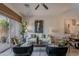 Well-lit living room with stylish seating, contemporary artwork, and a view to the outdoor patio through sliding glass doors at 19475 N Grayhawk Dr # 1039, Scottsdale, AZ 85255