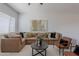 Open living room featuring a sectional sofa, stylish chairs, and neutral decor at 19475 N Grayhawk Dr # 1039, Scottsdale, AZ 85255
