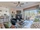 Spacious living area with a fireplace, comfortable seating, and an open layout leading to the kitchen and patio at 19475 N Grayhawk Dr # 1039, Scottsdale, AZ 85255