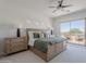 Main bedroom with balcony access, and a stylish bed frame flanked by matching nightstands at 19475 N Grayhawk Dr # 1039, Scottsdale, AZ 85255