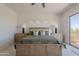 Bright main bedroom with a balcony, complemented by elegant furnishings and serene decor at 19475 N Grayhawk Dr # 1039, Scottsdale, AZ 85255