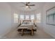 Sunlit main bedroom featuring a serene ambiance with multiple windows and neutral tones at 19475 N Grayhawk Dr # 1039, Scottsdale, AZ 85255