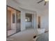 Spacious main bedroom showcasing balcony access and an open layout leading to other areas at 19475 N Grayhawk Dr # 1039, Scottsdale, AZ 85255