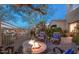 Cozy outdoor patio featuring a stone fire pit and comfortable seating area at 19475 N Grayhawk Dr # 1039, Scottsdale, AZ 85255