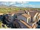 Aerial view of the residential neighborhood showcasing tile roofs and mountain views at 19475 N Grayhawk Dr # 1115, Scottsdale, AZ 85255