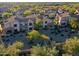 Community aerial view showcasing mature landscaping, desert vegetation and tile roofs at 19475 N Grayhawk Dr # 1115, Scottsdale, AZ 85255