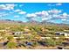 Expansive aerial view showcasing the residential area with mountains and clear blue skies at 19475 N Grayhawk Dr # 1115, Scottsdale, AZ 85255