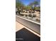 View of lush trees and bushes from the balcony, with a metal railing and a light brown concrete floor at 19475 N Grayhawk Dr # 1115, Scottsdale, AZ 85255