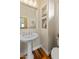 Stylish bathroom with a pedestal sink, built-in shelves, and neutral decor at 19475 N Grayhawk Dr # 1115, Scottsdale, AZ 85255