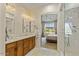 Bright bathroom with double sinks, tub, separate glass enclosed shower, and view of the mountains at 19475 N Grayhawk Dr # 1115, Scottsdale, AZ 85255