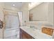 Well-lit bathroom featuring a shower-tub combo and granite vanity at 19475 N Grayhawk Dr # 1115, Scottsdale, AZ 85255