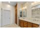 Spacious bathroom with double sinks, granite counters, large mirror and built in cabinets at 19475 N Grayhawk Dr # 1115, Scottsdale, AZ 85255