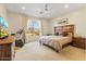 Cozy bedroom showcasing a large window with mountain views, carpet, and a ceiling fan at 19475 N Grayhawk Dr # 1115, Scottsdale, AZ 85255