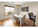 Bright dining room with hardwood floors, white table, and a large sunny window at 19475 N Grayhawk Dr # 1115, Scottsdale, AZ 85255