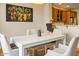 Bright dining room with wood floors, modern art, and seating for four at 19475 N Grayhawk Dr # 1115, Scottsdale, AZ 85255