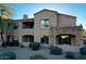 Stunning exterior with stone accents, balconies, and lush landscaping at 19475 N Grayhawk Dr # 1115, Scottsdale, AZ 85255