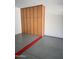 View of large storage cabinet in a garage on top of the epoxy flooring and a red wheel stop at 19475 N Grayhawk Dr # 1115, Scottsdale, AZ 85255