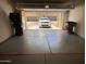 Spacious garage with epoxy flooring and a view of the front of the house through the open door at 19475 N Grayhawk Dr # 1115, Scottsdale, AZ 85255