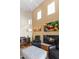 Bright living room featuring vaulted ceilings, fireplace, and a large television at 19475 N Grayhawk Dr # 1115, Scottsdale, AZ 85255