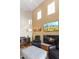 Bright living room featuring vaulted ceilings, fireplace, and a large television at 19475 N Grayhawk Dr # 1115, Scottsdale, AZ 85255