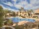 Community pool featuring a pergola, mature landscaping, and ample seating at 19475 N Grayhawk Dr # 1115, Scottsdale, AZ 85255
