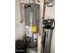 New Ruud water heater with a water filter, installed on top of a stone floor and next to white walls at 19475 N Grayhawk Dr # 1115, Scottsdale, AZ 85255