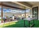 Covered patio with outdoor furniture, turf, and view of the pool and cabana at 2052 E Scorpio Pl, Chandler, AZ 85249