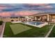 Well-manicured backyard boasts a pool, spa, putting green, and covered patio, ideal for outdoor entertainment and recreation at 2052 E Scorpio Pl, Chandler, AZ 85249