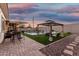 Inviting backyard featuring a pool, gazebo, outdoor seating, and beautiful landscaping, perfect for relaxation and entertaining at 2052 E Scorpio Pl, Chandler, AZ 85249