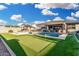 Gorgeous backyard featuring a pool, putting green, cabana, covered patio, and turf at 2052 E Scorpio Pl, Chandler, AZ 85249