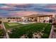 Lush backyard featuring a pool, spa, putting green, and a covered patio, designed for ultimate outdoor living at 2052 E Scorpio Pl, Chandler, AZ 85249
