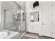 Bathroom features glass shower and soaking tub with white cabinets and TV at 2052 E Scorpio Pl, Chandler, AZ 85249