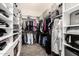 A walk-in closet has built in shelving and ample storage for clothes and accessories at 2052 E Scorpio Pl, Chandler, AZ 85249