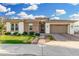 Charming home featuring manicured lawn, beautiful brick accents, and a lovely paver driveway leading to a two-car garage at 2052 E Scorpio Pl, Chandler, AZ 85249