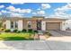 Charming home featuring manicured lawn, beautiful brick accents, and a lovely paver driveway leading to a two-car garage at 2052 E Scorpio Pl, Chandler, AZ 85249