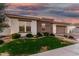 Charming home featuring manicured lawn, beautiful brick accents, and a lovely paver driveway leading to a two-car garage at 2052 E Scorpio Pl, Chandler, AZ 85249