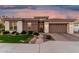 Charming home featuring manicured lawn, beautiful brick accents, and a lovely paver driveway leading to a two-car garage at 2052 E Scorpio Pl, Chandler, AZ 85249