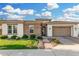 Charming home featuring manicured lawn, beautiful brick accents, and a lovely paver driveway leading to a two-car garage at 2052 E Scorpio Pl, Chandler, AZ 85249