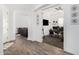 Bright hallway showcasing modern flooring leading to a cozy living area and an office space at 2052 E Scorpio Pl, Chandler, AZ 85249