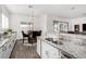 Open kitchen boasts stainless steel appliances, granite countertops, and a breakfast nook at 2052 E Scorpio Pl, Chandler, AZ 85249